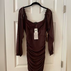Bodycon style dress with shirring on sides. NWT